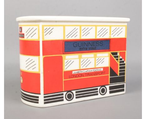 A Carlton Ware ceramic money box, formed as a London Transport Double Decker bus, No. 6 - Wimbledon, advertising Guinness Ext