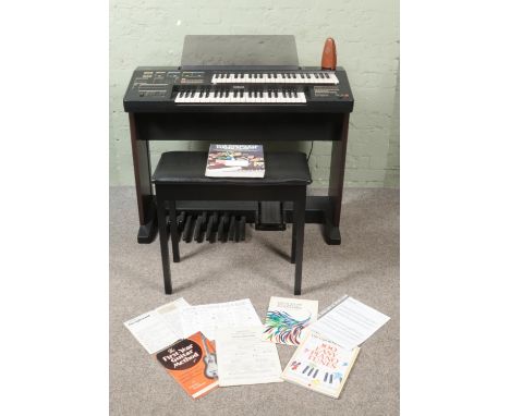 A Yamaha Electone HC-2 Electronic Organ, with footstool, a large collection of sheet music and metronome. With cover. In work