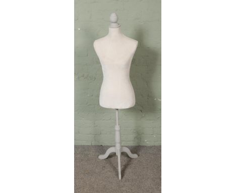 A velvet covered display mannequin torso on painted wooden stand.