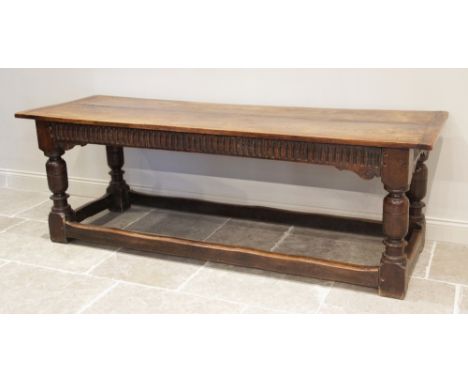 A 17th century and later oak refectory table, the rectangular twin plank cleated top above a nulled frieze, raised upon subst