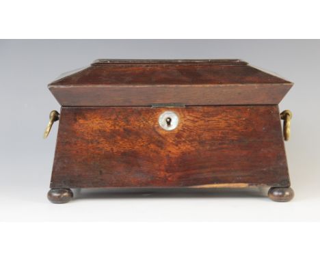 A William IV walnut tea caddy, early 19th century, of sarcophagus form on bun feet with drop ring handles and mother of pearl