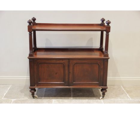 A Victorian mahogany dumb waiter, the three quarter galleried top shelf enclosed by octagonal urn shaped finials, and raised 