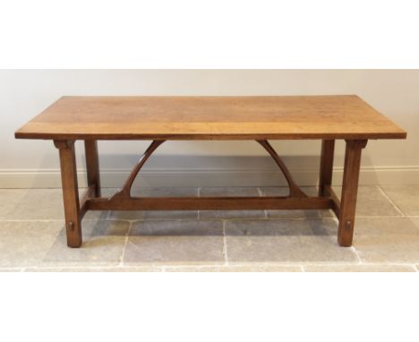 An early 20th century Arts and Crafts honey oak refectory table in the manner of Ernest Gimson (1864- 1919), the rectangular 