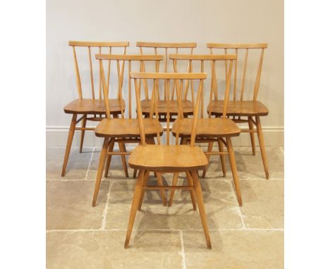 A set of six 1960's Ercol blonde elm and beech wood kitchen chairs, each chair with a stick back above a shaped elm seat, rai