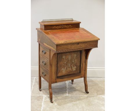 A late Victorian rosewood Davenport, the rectangular hinged top with a gilt metal baluster gallery opening to a compartmental