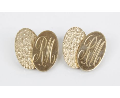 A pair of 9ct gold cufflinks by Deakin &amp; Francis, Birmingham 1970, each designed as oval panels, one with engine turned t