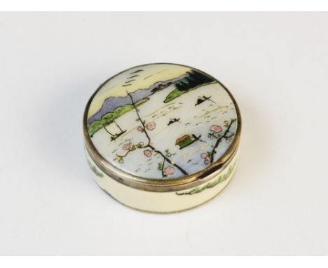 An early 20th century Austrian silver and enamel pill box, of circular form decorated in polychrome enamel with gilt highligh