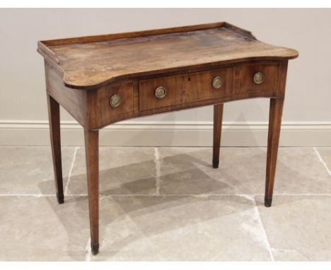 A George III mahogany dressing/side table, the rectangular galleried top with extended and rounded front corners, over three 