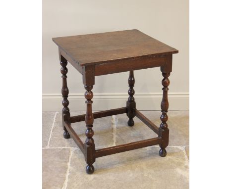 A 17th century oak side table, the rectangular twin plank top raised upon four bobbin and baluster turned legs, united by per