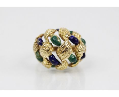 An 18ct gold enamelled 'bombe' ring, the openwork woven design head with textured engraving and blue and green enamel decorat