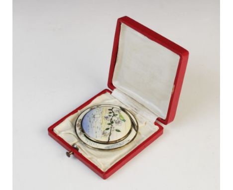 An early 20th century Austrian silver and enamel compact, of circular form decorated in polychrome enamel with gilt highlight