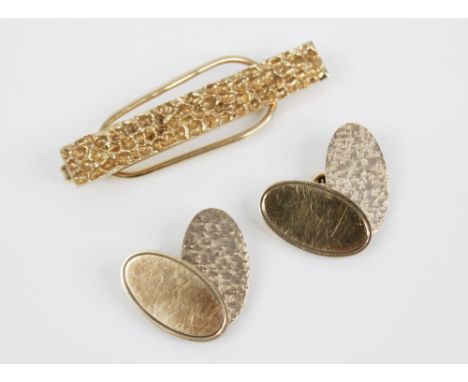 A pair of 9ct gold cufflinks by Cohen &amp; Charles, Birmingham 1966, each designed as two oval panels, one with engine-turne