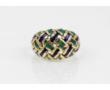 An 18ct gold enamelled ring, the pierced braided design head decorated with green and blue enamel, set to a tapering shank, s