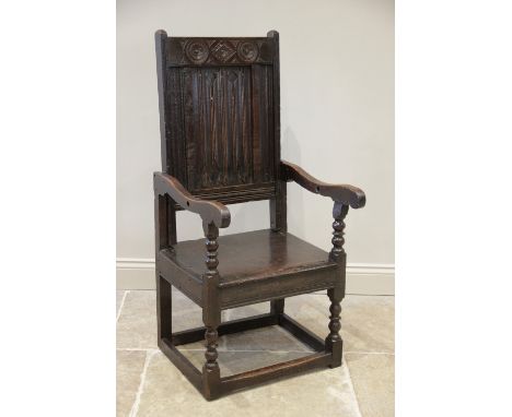 A 17th century and later, oak Wainscot chair, the associated carved linen fold back rest above the board seat, raised upon fr