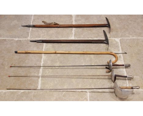 An Austrian Stubai ice pick, the oak shaft with steel spike and head stamped with the makers name, 95cm long, a second ice pi