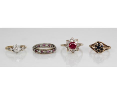 A synthetic ruby and white paste 9ct gold dress ring, designed as a central round mixed cut ruby with a surround of eight rou