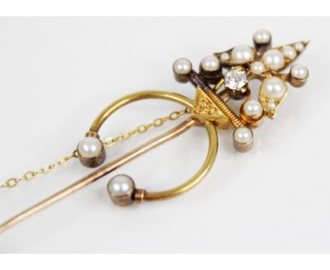 A 19th century and later diamond and pearl stick pin, the yellow metal foliate design terminal comprising a principle old cut