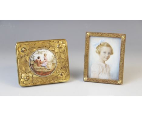 An Edwardian watercolour on ivory portrait miniature, early 20th century, depicting a young girl with a blue ribbon in her ha