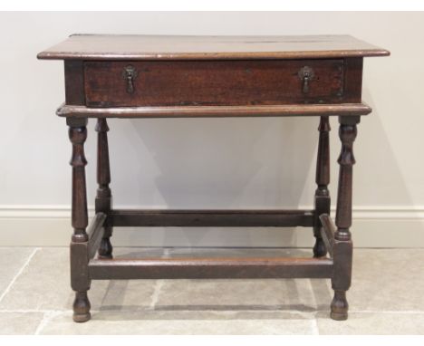 An 18th century oak side table, the rectangular moulded plank top above a single frieze drawer applied with later droplet han
