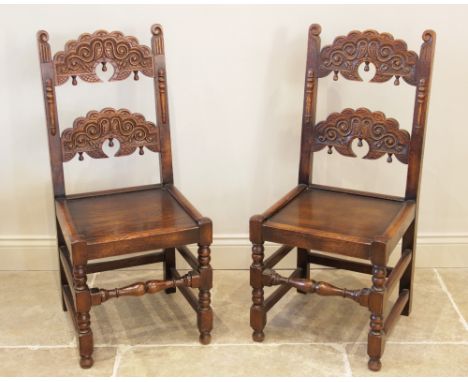 A pair of 17th century style oak Derbyshire side chairs, 20th century, each chair carved with twin crescent shaped back rails