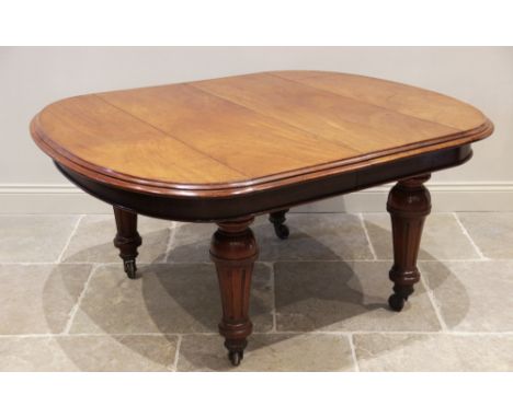 A Victorian mahogany extending dining table, the oval table top with a moulded edge above a plain frieze, raised upon substan
