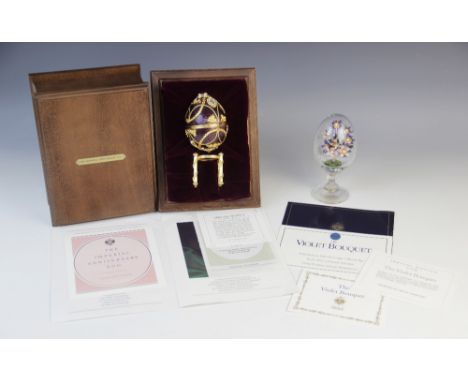 A Frankin Mint 1984 House of Igor Carl Faberge Imperial Anniversary Egg, the silver egg with purple guilloche enamel decorati