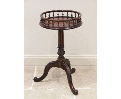 A 19th century and later Chippendale style galleried mahogany wine table, the circular top with a spindle gallery upon an ass