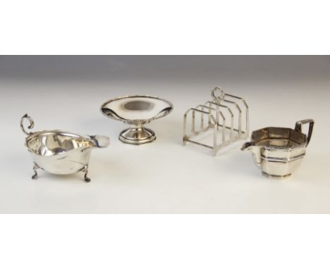 A George VI silver four-division toast rack by HF Withers, Birmingham 1936, 7.8cm long, together with an Edwardian silver mil