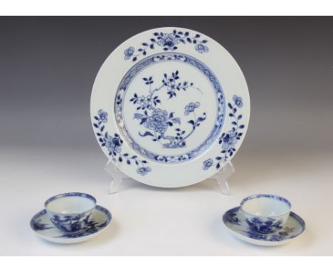 A Chinese porcelain blue and white plate, 18th century, the central panel with prunus blossom tree and chrysanthemums within 