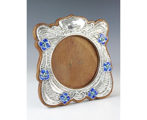 An Art Nouveau silver and enamel photograph frame, Synyer & Beddoes, Birmingham 1904, of shaped square form with silver tendr