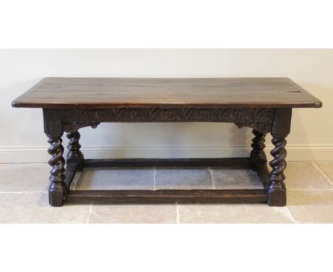 A 17th century oak refectory table, the cleated three plank top above a foliate lunette carved frieze, raised upon substantia