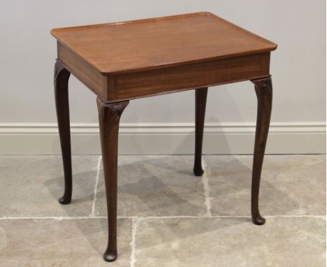 A George II and later Irish mahogany silver table, the later rectangular tray top raised on four shell capped slender cabriol