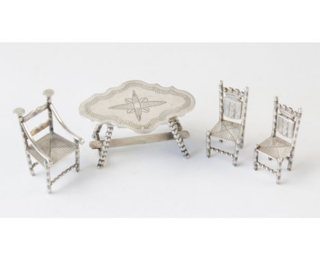 A selection of miniature continental silver coloured doll's house furniture, to include; a bobbin-legged table with ogee top 