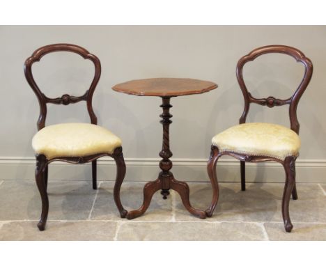 A mid 19th century walnut pedestal occasional table, the shaped and figured top raised upon a turned baluster column extendin