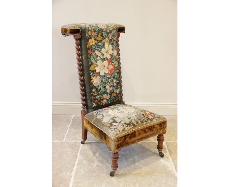 A Victorian walnut and upholstered prie dieu chair, the foliate tapestry high back flanked by barley twist pilasters, above t