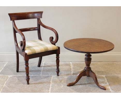 A George III oak tripod table, the circular top upon a reduced ring turned baluster pedestal, extending to three cabriole dow