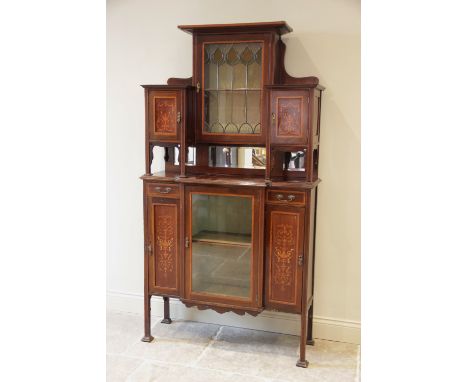 An Edwardian inlaid mahogany display cabinet, the architectural high back formed with a central leaded glazed door applied wi