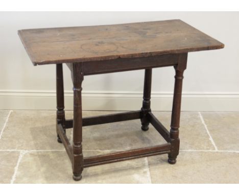 An 18th century and later oak side table, the cleated twin plank rectangular top above a plain frieze, raised upon ring turne