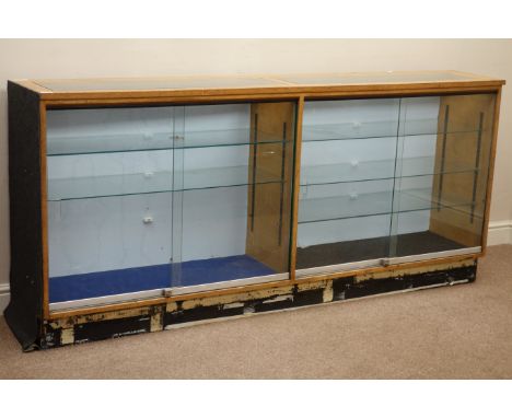 Double light oak and glazed illuminated shops display cabinet enclosed by sliding glass doors, adjustable glass shelves, W204