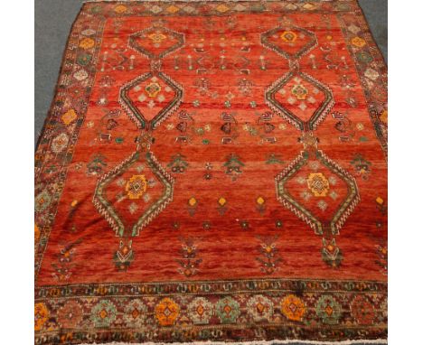 Persian rug carpet, large red field with stylised decoration, 290cm x 220cm   Condition Report   Click here for further image