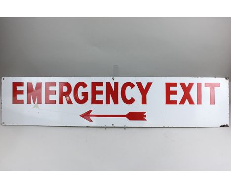 A mid 20th century industrial sign, 'Emergency Exit' in red lettering with arrow, on white ground, 23cm by 107cm