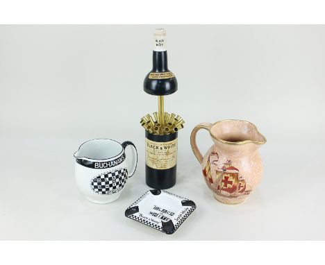 A novelty musical cigarette dispenser in the form of a Buchanan's 'Black &amp; White' Scotch whisky bottle, 28.5cm, a Buchana