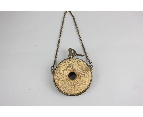 A brass mounted gunpowder flask with embossed design of nude female figures