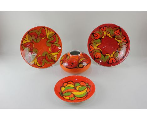 Four pieces of Poole Pottery Delphis by Carolyn Wills, including a globular vase, two dishes in red and orange, and a smaller