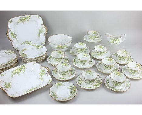 A Wedgwood Etruria porcelain part tea service with green floral decoration on white ground, with gilt embellishments, compris