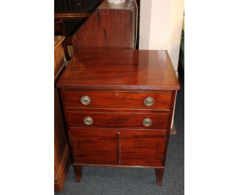 A mahogany cupboard, the rectangular cross-banded top with fluted edge above two drawers and two cupboard panel doors, on sab