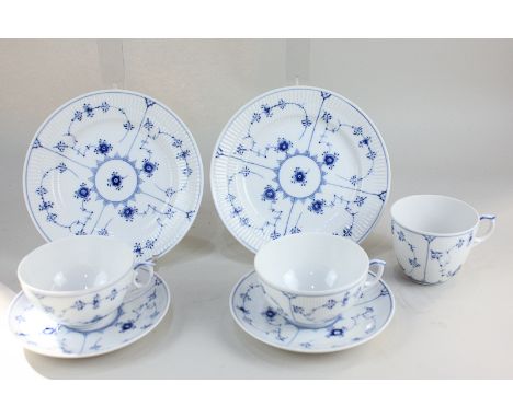 A Royal Copenhagen porcelain part tea set comprising two teacups, one coffee cup, two saucers, and two plates, in blue floral