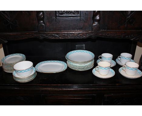 A Mintons porcelain part tea and dinner service with turquoise looped border on white ground and gilt embellishments, compris