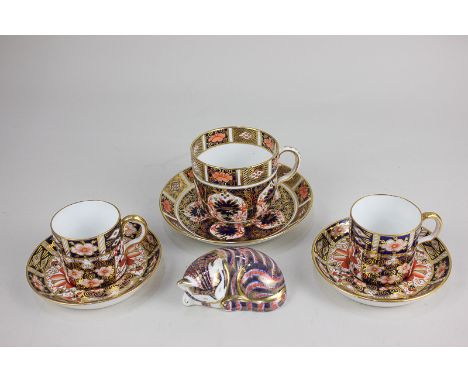 A Royal Crown Derby porcelain teacup and saucer in the Imari pattern 1128, together with a pair of coffee cups in the Imari p