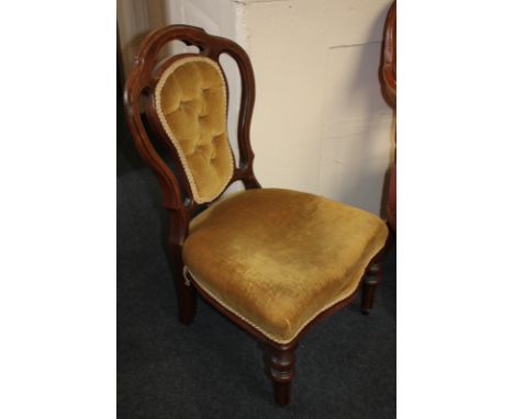A Victorian upholstered nursing chair, with button upholstered back, on turned and fluted legs with castors, (a/f)
